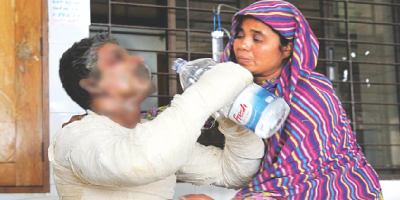 Illius Biswas, a Victim of the Arson Attack on a Truck, Tries to Quench his Thirst 